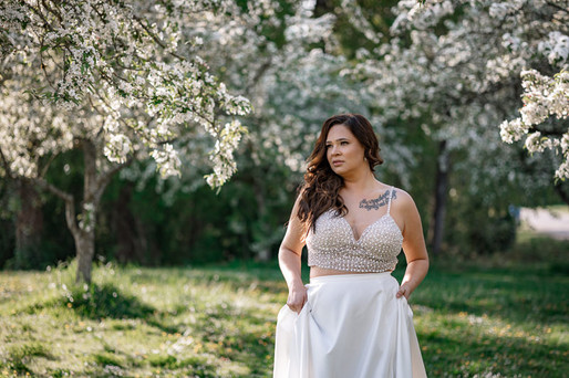 bride walking through Bridal portraits in Vancouver cherry blossoms