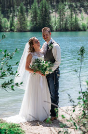 Bride and groom lake pose