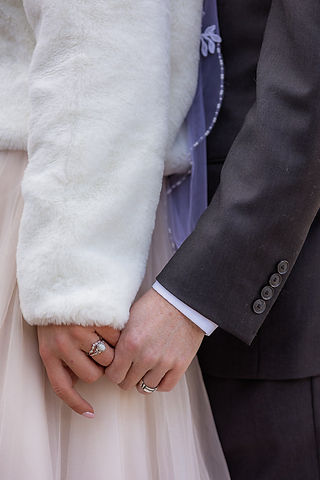 Bride and groom holding hands