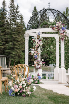 outdoor ceremony set up with purple florals