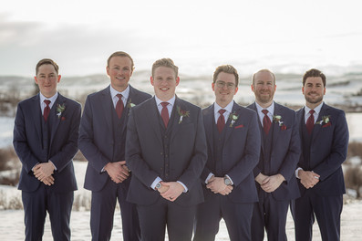 Groomsmen bridal party with groomsmen standing behind groom in v formation