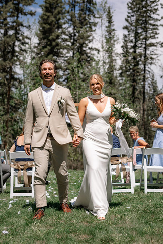Newlyweds walking back down the aisle after their ceremony at an Airbnb wedding venue