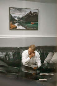 A candid moment capturing the groom reading a heartfelt note, his eyes teary-eyed