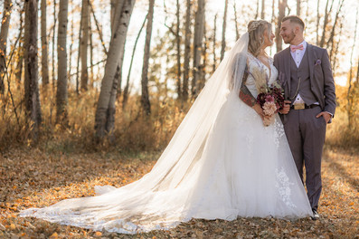 bride and groom in forest sunset