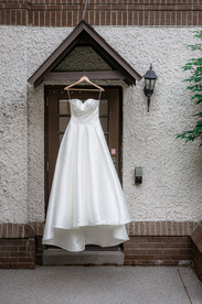 Bride a-line down hanging infront of doorway 