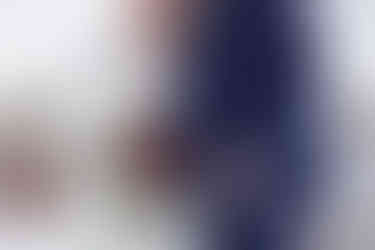 Detail shot of brides florals as she stands beside groom