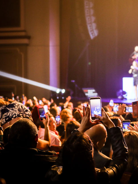 Packed concert crowd watching Myriam Hernández perform live on stage.