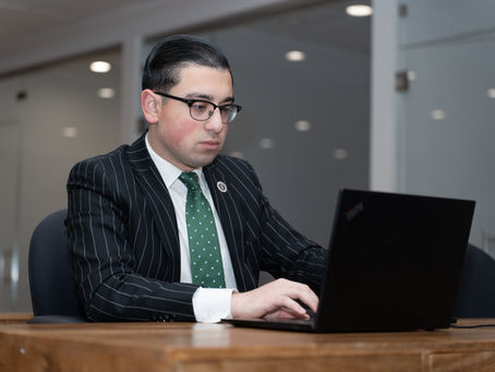 Working professional studying self-paced real estate courses on a laptop for his New Jersey real estate license