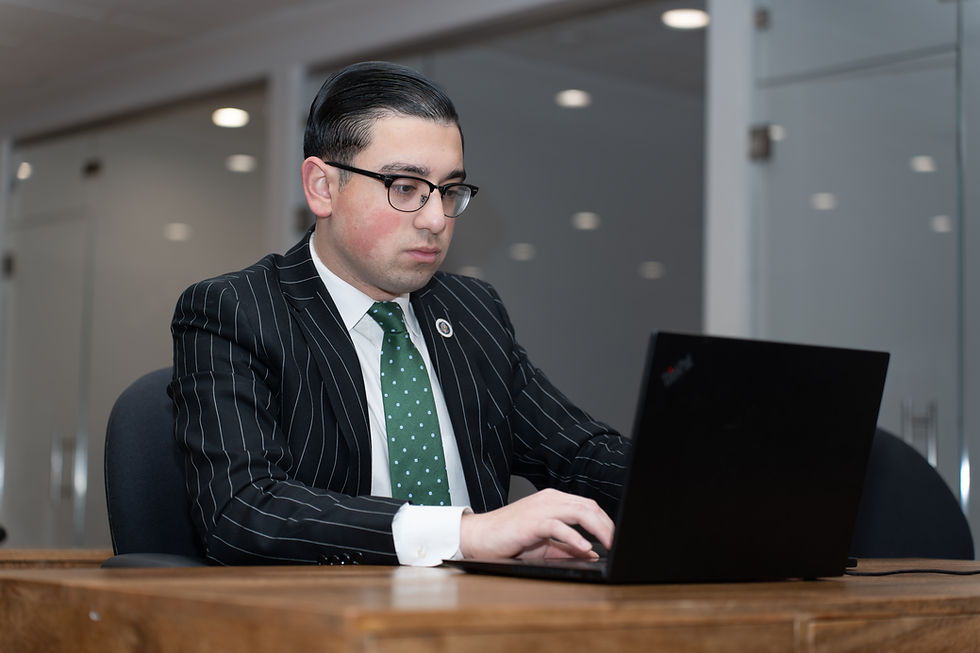 Working professional studying self-paced real estate courses on a laptop for his New Jersey real estate license