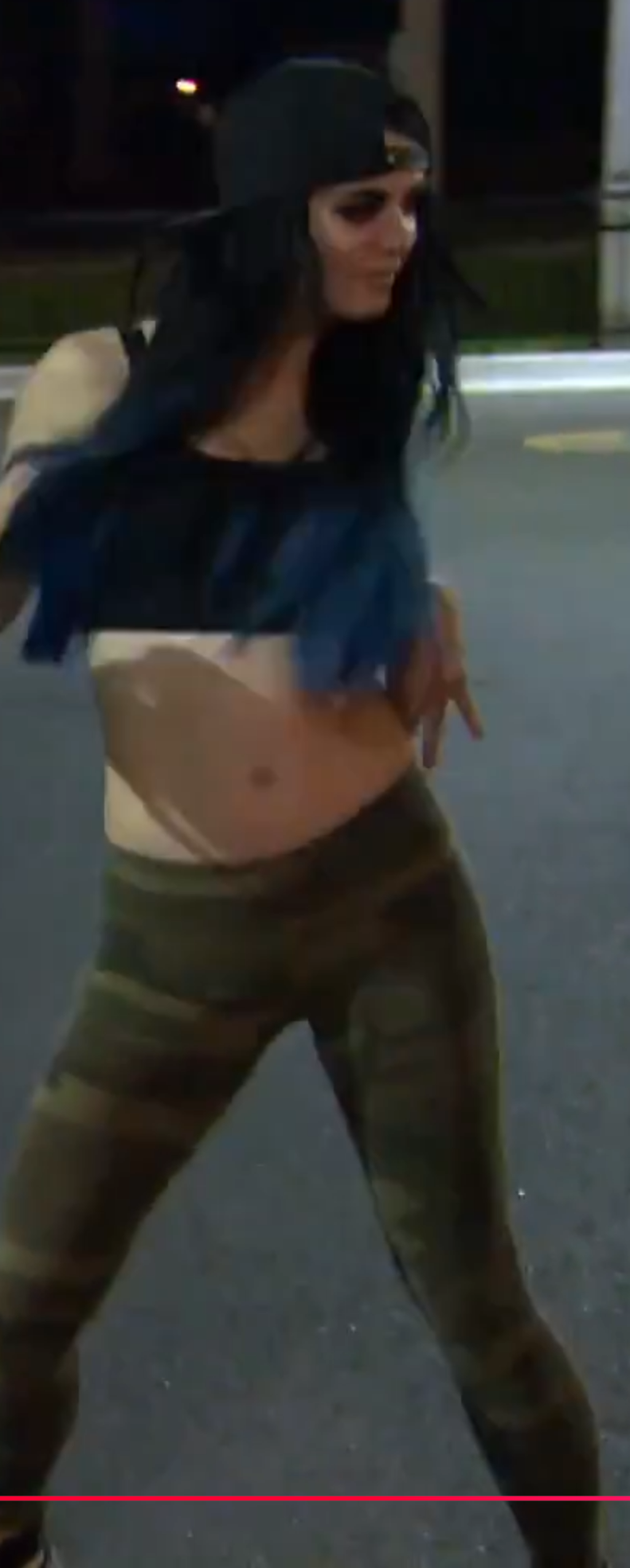 Paige striking a pose in a black crop top and cameo leggings.