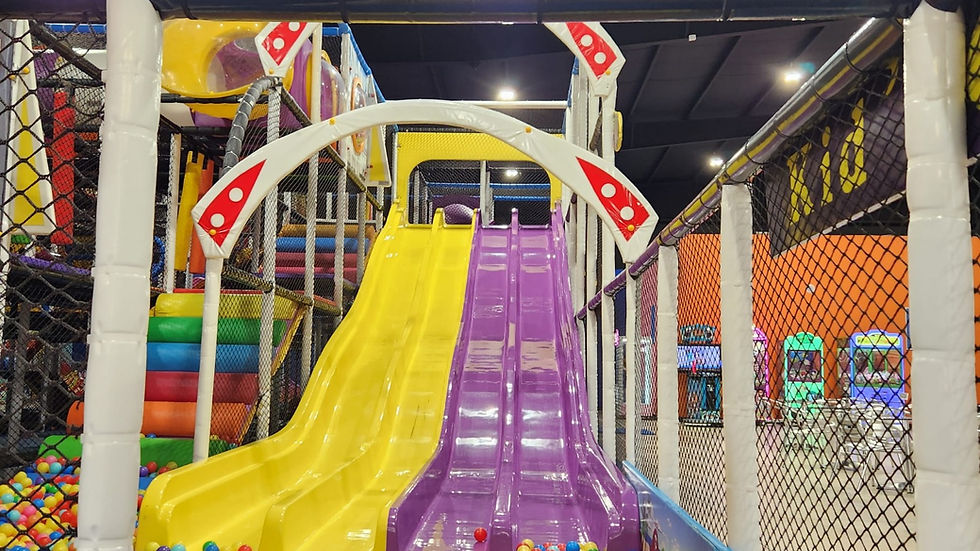 Colorful indoor playground featuring vibrant slides and a cheerful ball pit, providing a fun and engaging space for children to explore and play in OKC.