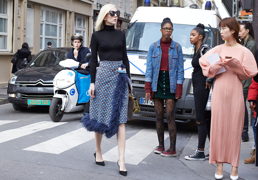 Fashion Documentary - fashionably dressed woman crosse the street as others look on.