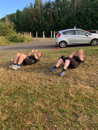 Two people doing sit-ups