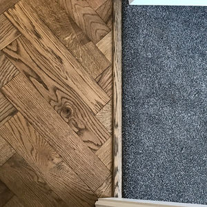 Close-up of two flooring types meeting