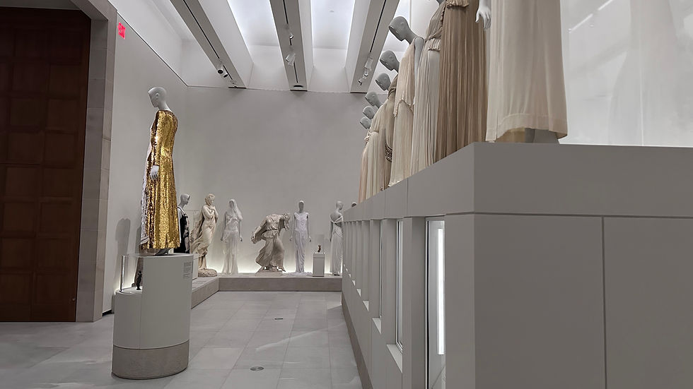 A contemporary avant-garde dress displayed on a mannequin next to a 19th-century oil painting.