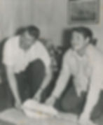 Two men hold a large plaster cast of a Bigfoot footprint.