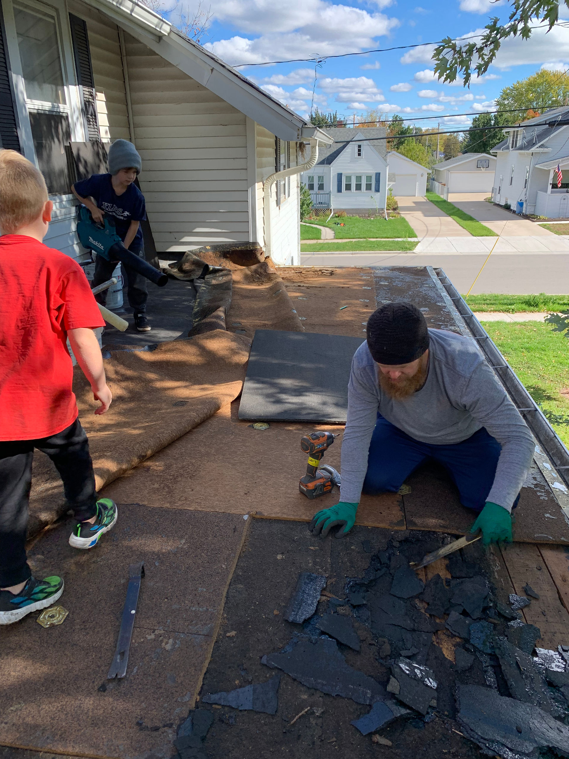 Crown Roofing Services President fixing flat roof of his own home.