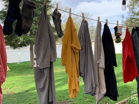 Clothes hanging on a line outside because our dryer broke.