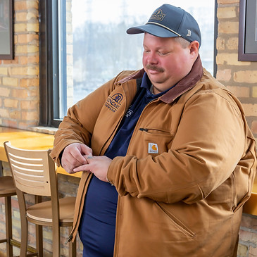 Jeremy Stroik looking at his wedding tattoo.
