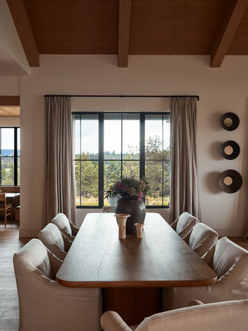 A dining table with very comfortable upholstered chairs.