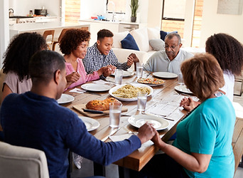 Black-Family-Praying-Before-Their-Holiday-Meal.jpeg