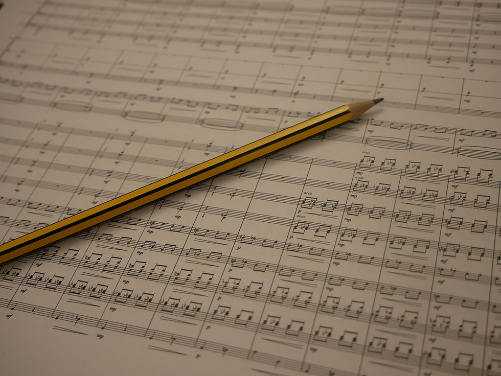 Pencil resting on a printed orchestral score.
