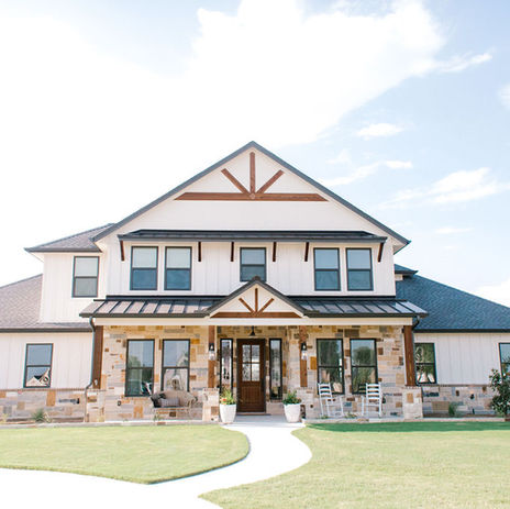 The exterior of Our Abode includes farmhouse gables and beautiful wood posts near its covered porch.