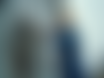 Technician inspecting an air conditioning unit outside a commercial condo building