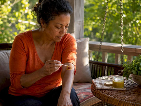 Woman applying herbal ointment on wound