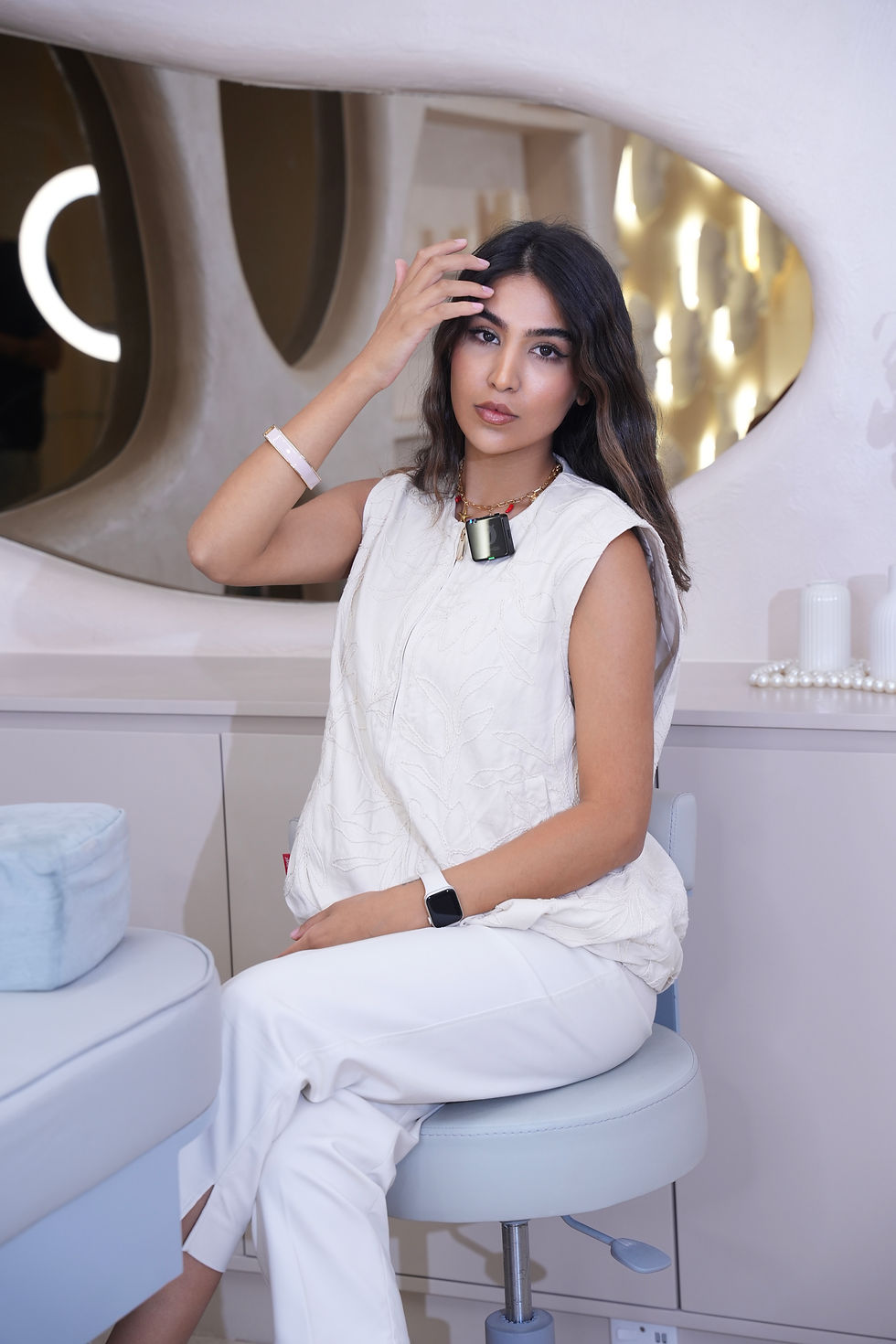 Portrait of instructor Zahra Hosseini sitting in a modern beauty studio