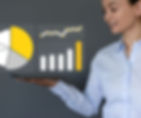 A woman hold a tablet and superimposed above it are three visualizations, a pie chart, a line graph, and a bar graph