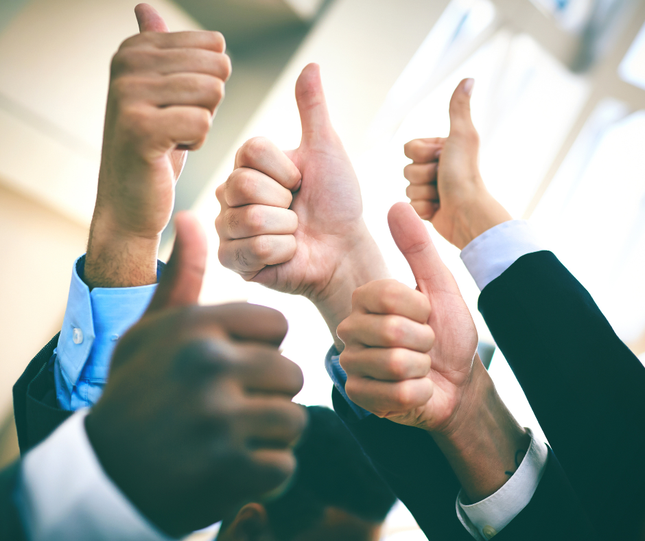 A diverse group of human hands give a thumbs up