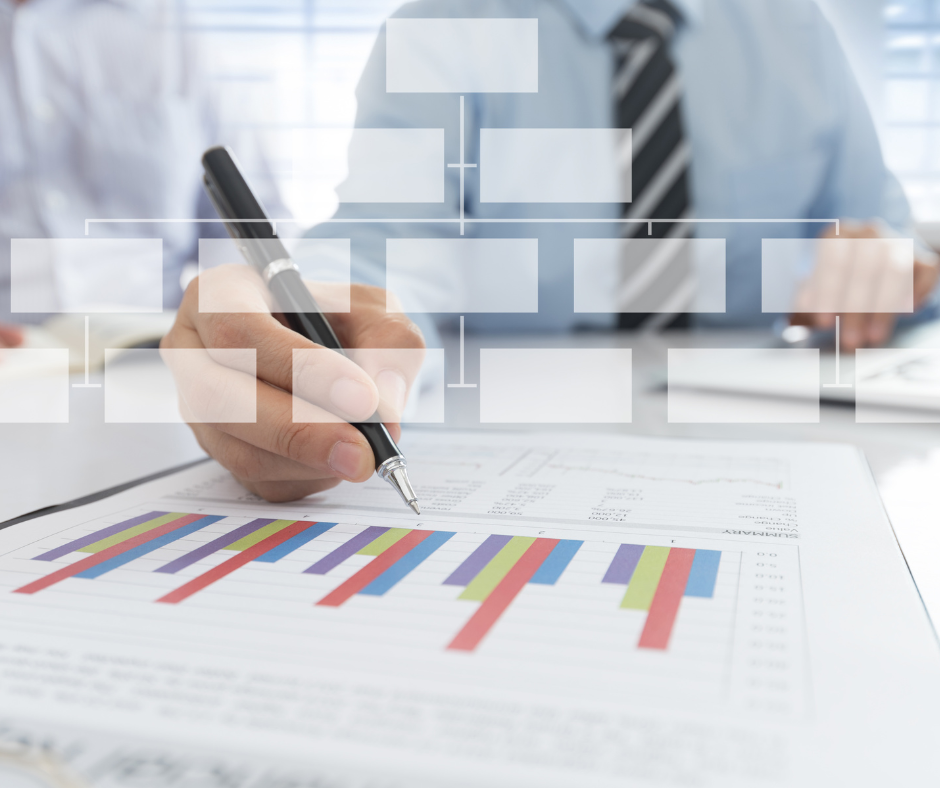 A business person working on graphs with on overlay of an organizational chart