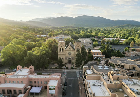 An image of Santa Fe from the air, with mountains behind it