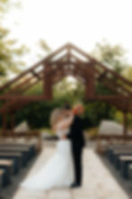 Photo by Myranda Peyatt Photography - Bride and Groom Under the Outdoor Wedding Ceremony Arch