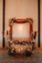 Wedding table with "Mr & Mrs" sign, floral arrangements, candles, draped fabric, and "Happily Ever After" neon sign in cozy setting at luxurious West Virginia wedding venue near Charleston, WV.