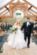 bride and groom walking down outdoor wedding aisle at luxurious West Virginia wedding venue, photo t