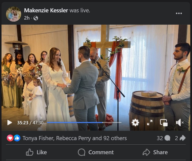 Bride and groom exchange vows in a rustic wedding venue in Hico WV with a wooden cross backdrop. Indoor wedding ceremony in white wedding venue near Summersville WV