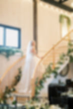 Photo by Melissa Kincaid Photography - bride standing on beautiful grand staircase inside Evermore R
