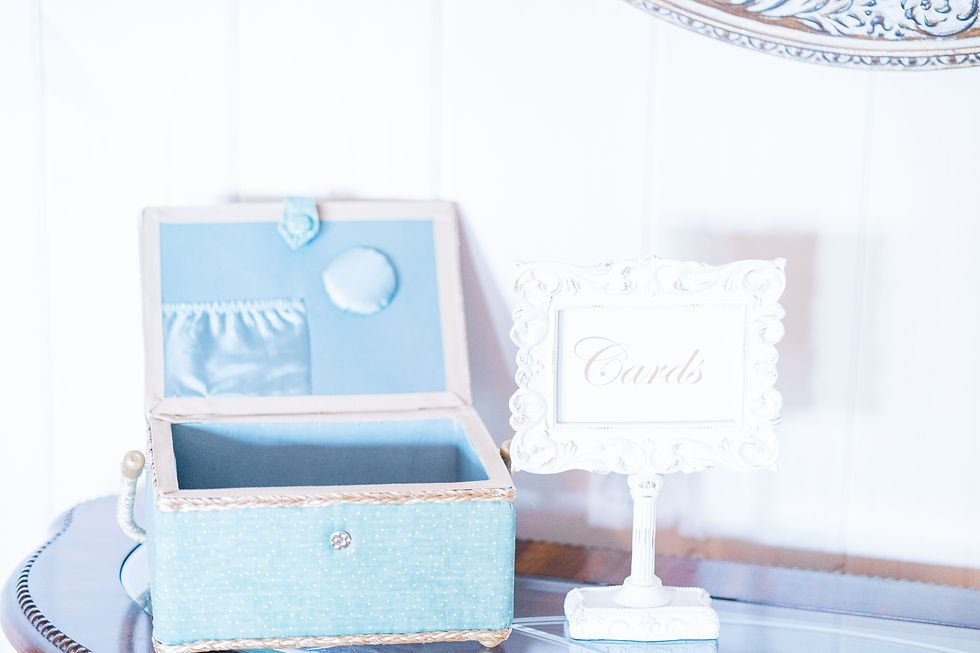 Light blue box on a wooden table with open lid; white sign beside it reads "Cards." Elegant, decorative, and serene setting at Charleston, WV wedding venue.