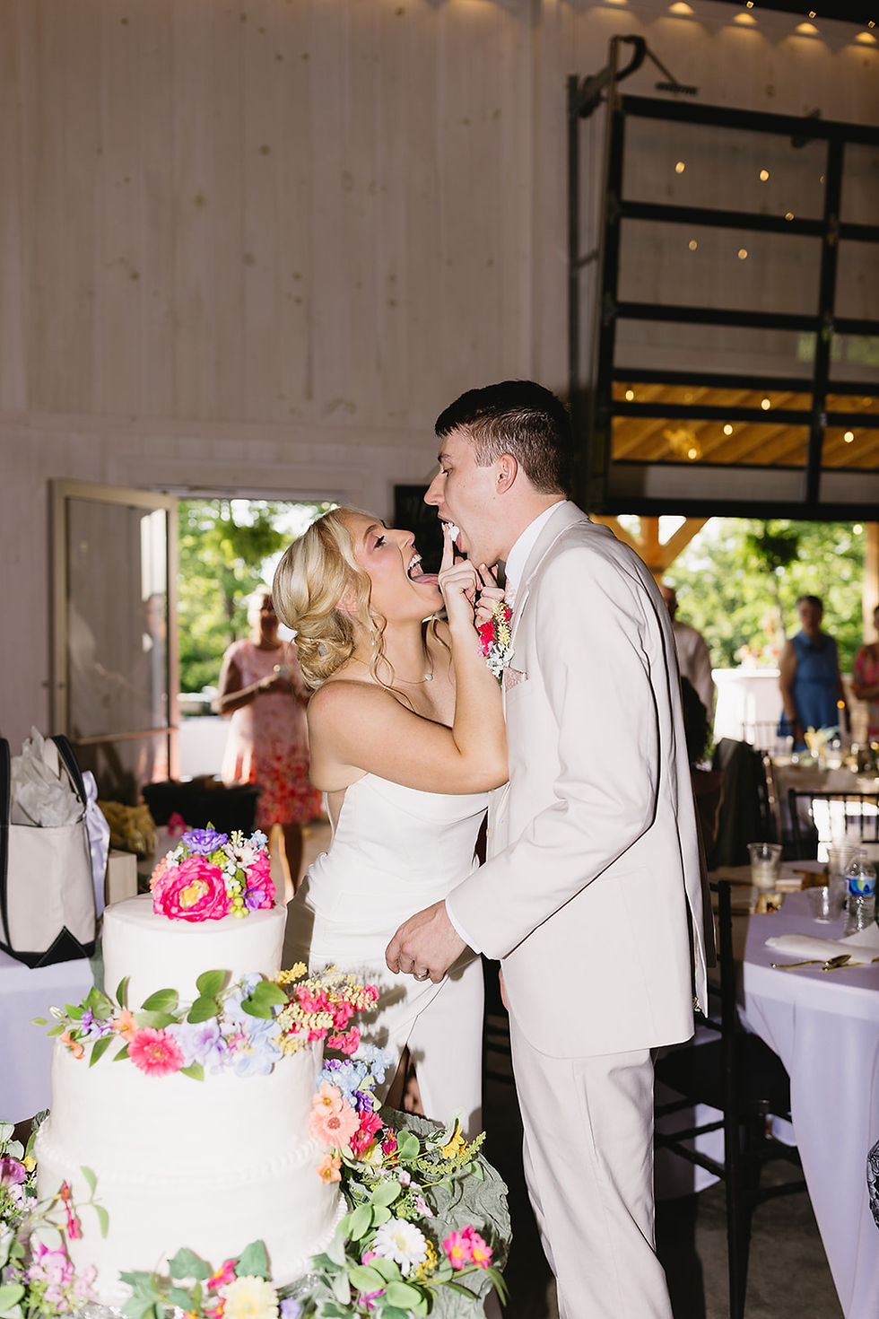 Photo by Leah Stankus Photography - couple cuts wedding cake inside West Virginia wedding venue