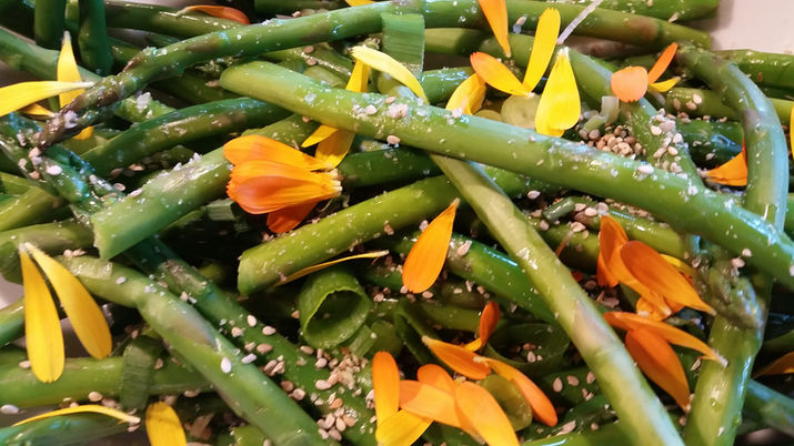 Green beans with orange edible flower petals
