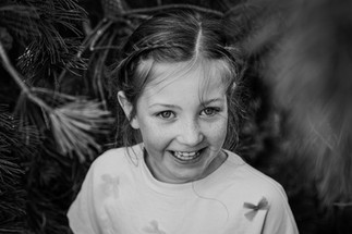 Black and white close-up of a young girl laughing.