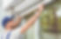 Man measuring window prior to installation of roller shutter outdoors.jpg