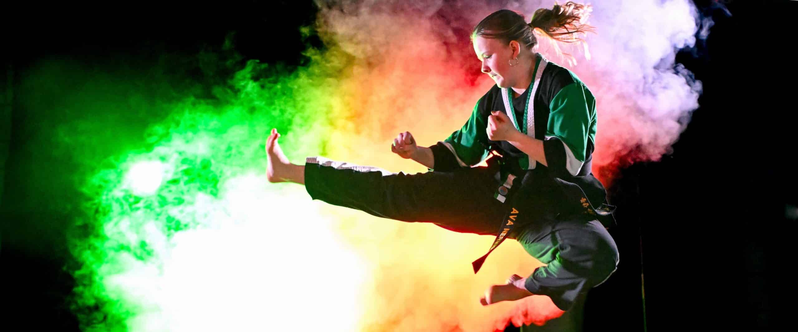 a student flies through the air with a stellar side kick