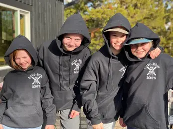 children wearing hoodies with 'pow pow rocks' printed on them