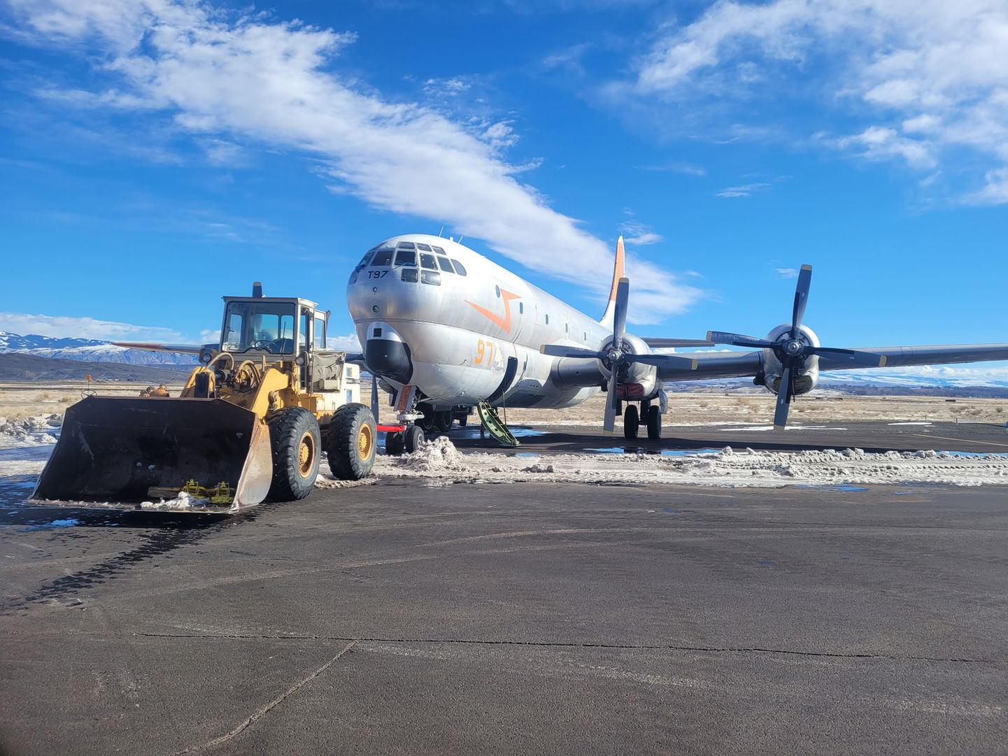 A tractor begins the journey of hauling the 97 off the runway of the airport in Greybull, Wyoming.