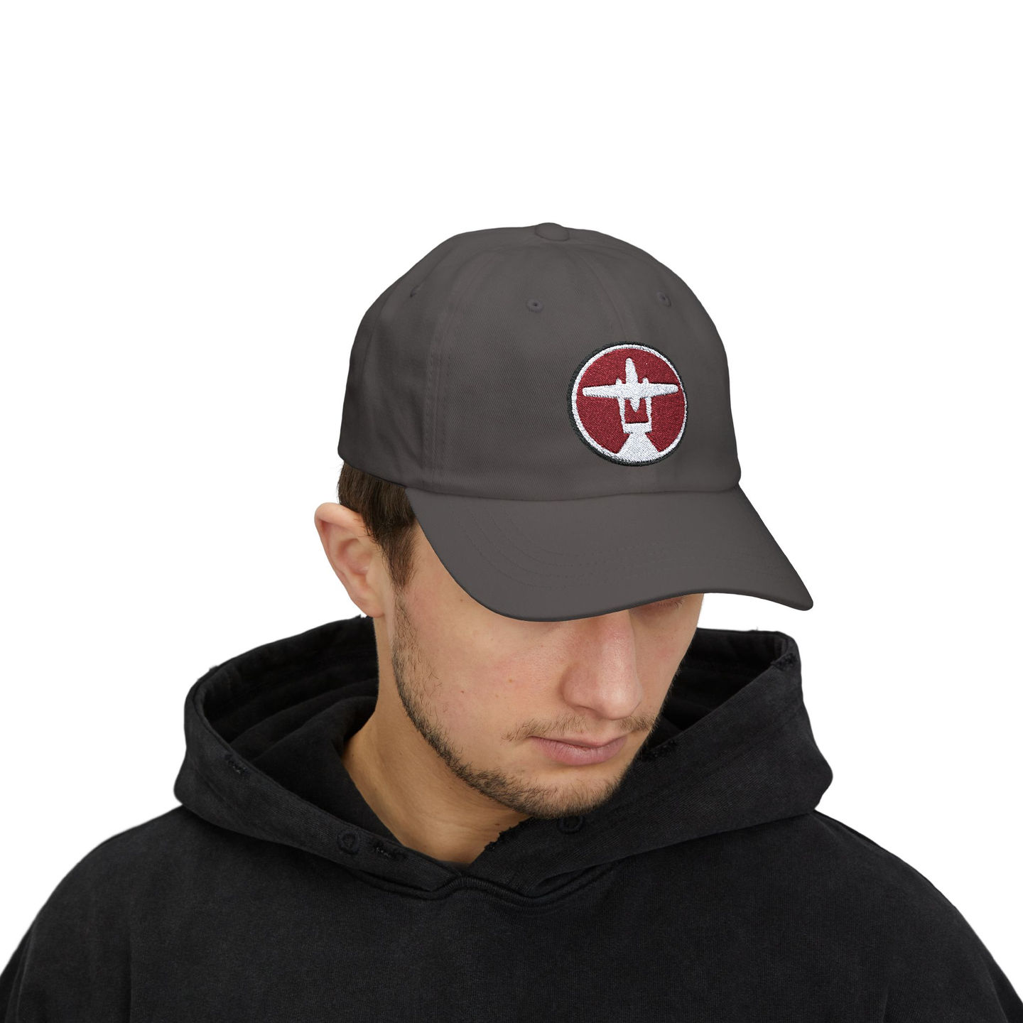 Person wearing dark gray cap with airplane logo