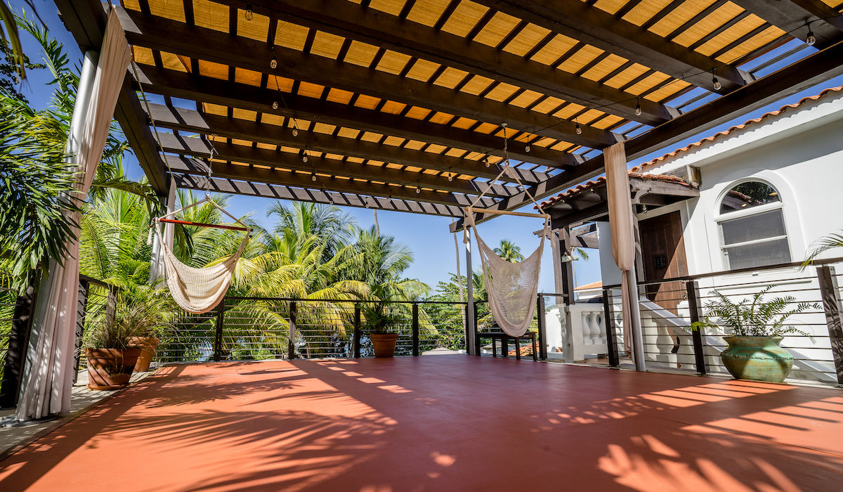 Relaxing outdoor patio with hammocks, offering tranquil views