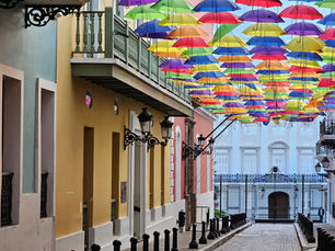 Umbrellas cover a cobblestone street in Old San Juan